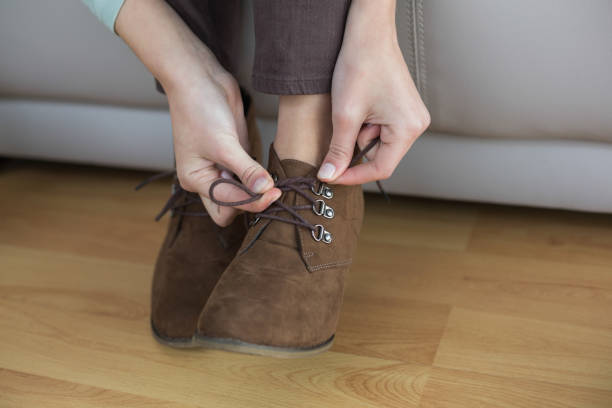 istock Slender woman tying her shoelaces 852199520