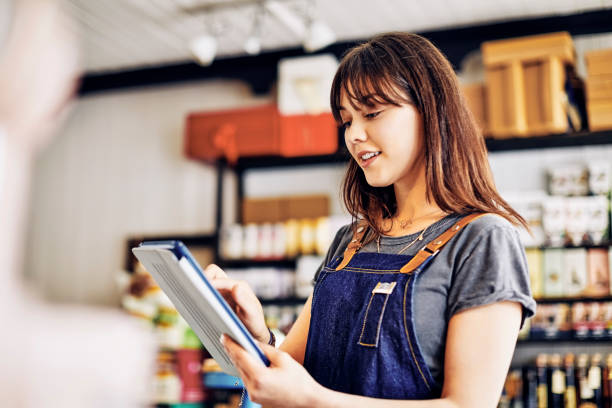 istock Beautiful young saleswoman using digital tablet in deli 852199700