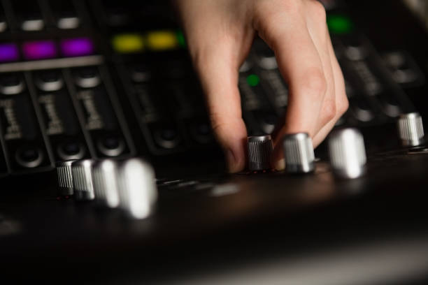 istock Hand of female audio engineer using sound mixer 852199838