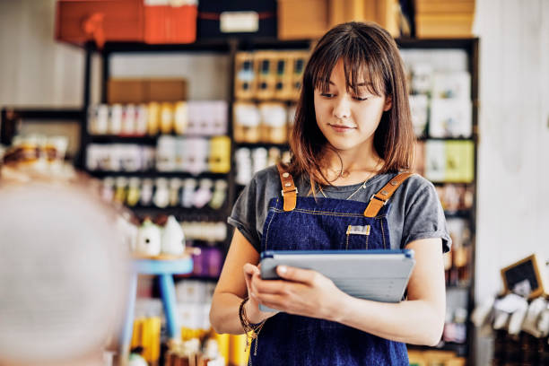 istock Beautiful young entrepreneur using digital tablet in delicatessen 852200644
