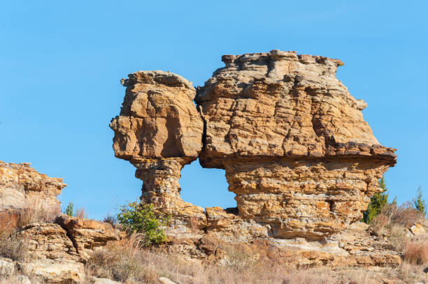 This rock formation is called the “Old Maid” and is located in Cimarron county, Oklahoma, near Black Mesa State Park.
