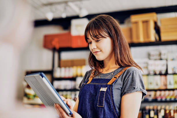 istock Beautiful entrepreneur using digital tablet in delicatessen 852203752