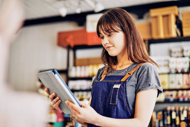 istock Young female entrepreneur using digital tablet in deli 852203828