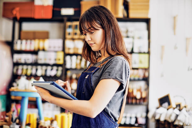 istock Confident young deli owner using digital tablet in store 852204314