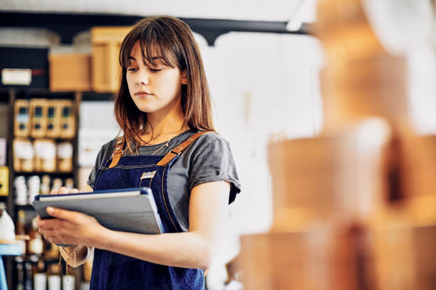 istock Confident young saleswoman using digital tablet in deli store 852205276