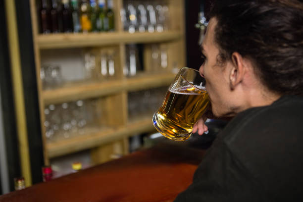 istock Man having a mug of beer at counter 852205404