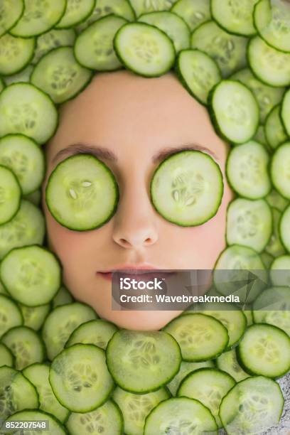 Beautiful Woman With Facial Mask Of Cucumber Slices On Face Stock Photo - Download Image Now