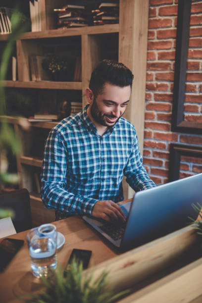 istock Young Smiling Freelancer Working In Cafe Restaurant 852208370