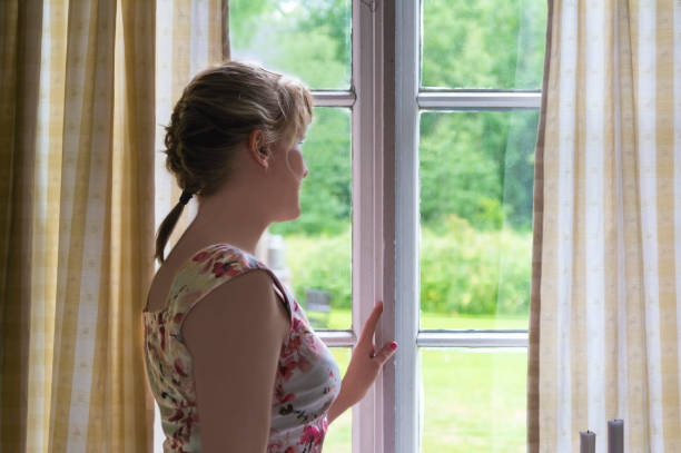istock Woman looking out of window 852208450