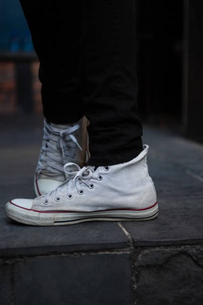istock Low section of man wearing white canvas shoes 852214390