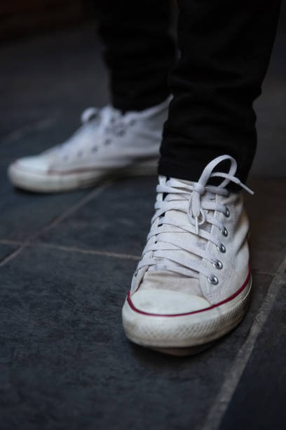 istock Low section of man wearing white canvas shoes 852214440