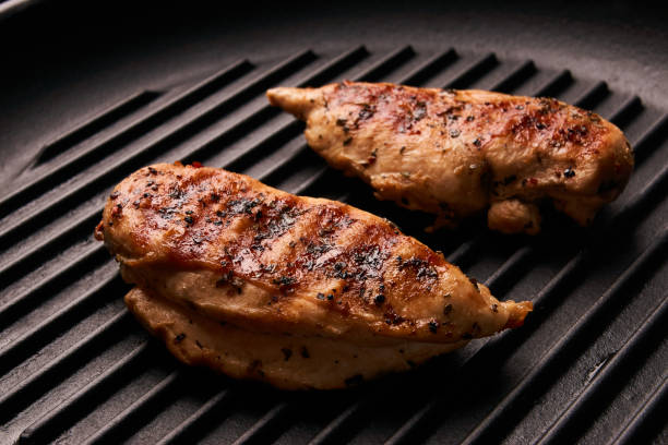 istock Grilled chicken breast fillets on black ribbed cooking pan 852214490