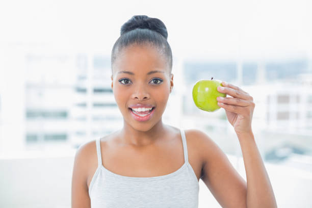 istock Attractive woman holding green apple 852214848