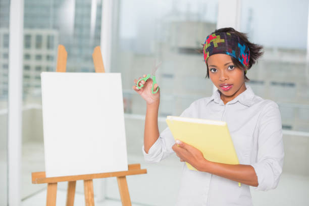 istock Attractive artistic woman holding sketchpad and scissors 852223598