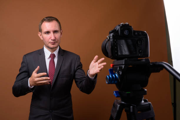 istock Studio shot of businessman vlogging while wearing suit against colored background 852224752