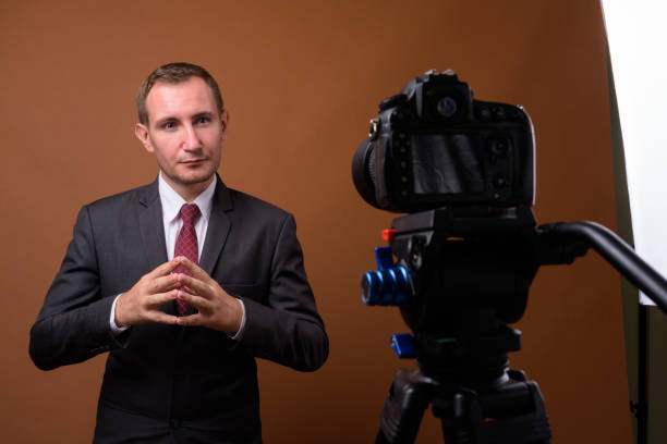 istock Studio shot of businessman vlogging while wearing suit against colored background 852224802