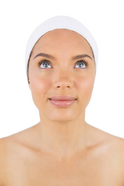 istock Smiling woman wearing white headband looking upwards 852224894