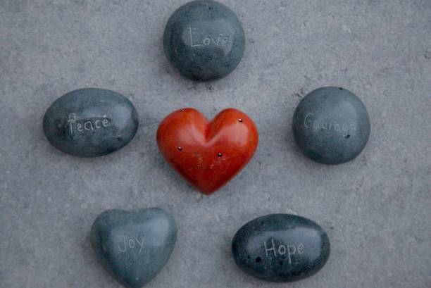 Heart shape pebbles frame isolated on white background