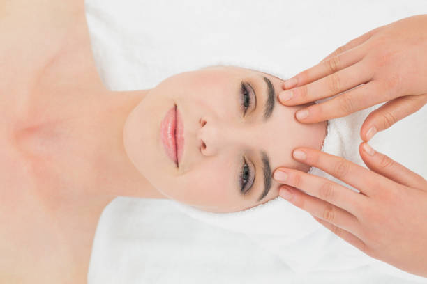 istock Hands massaging womans forehead at beauty spa 852233596