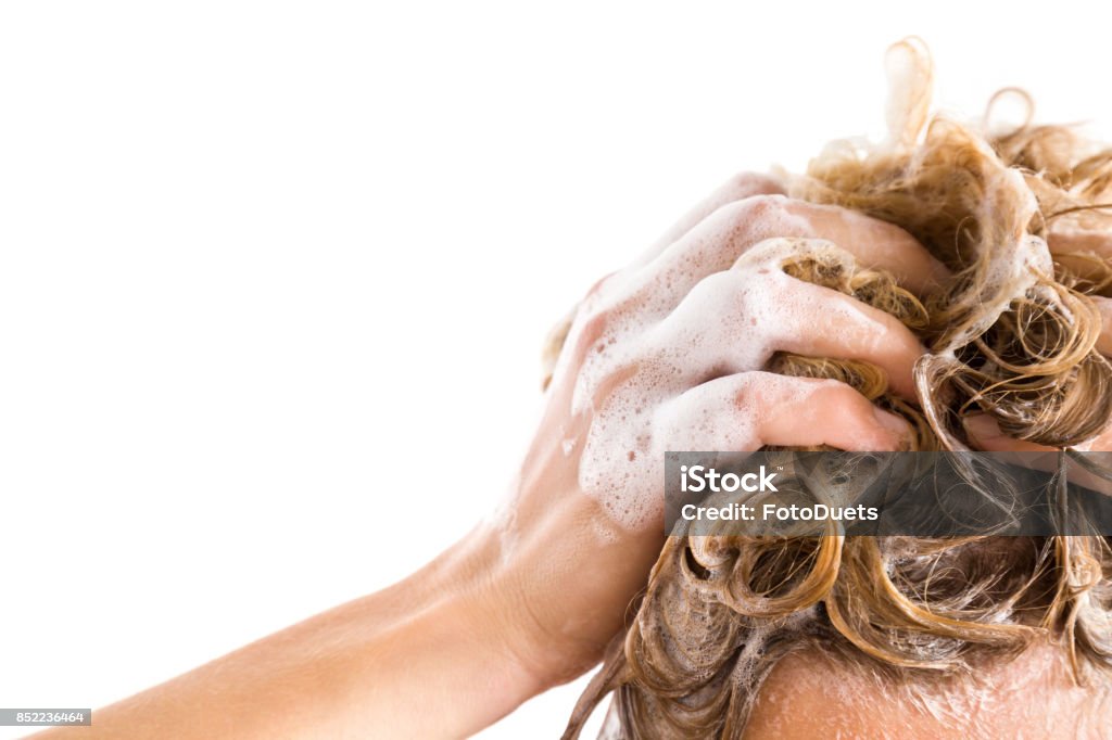 Woman's hand with shampoo washing hair isolated on the white background. Cares about a healthy and clean hair. Beauty salon. Empty place for a text. Shampoo Stock Photo