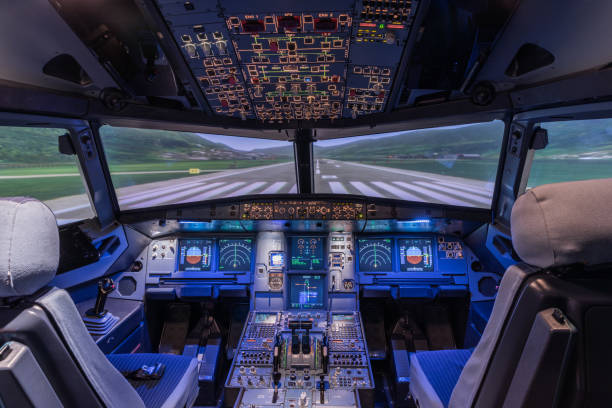 A view of the cockpit of a large commercial airplane, a cockpit trainer. A view of the cockpit of a large commercial airplane, a cockpit trainer. Cockpit view of a commercial jaircraft cruising passenger cabin stock pictures, royalty-free photos & images