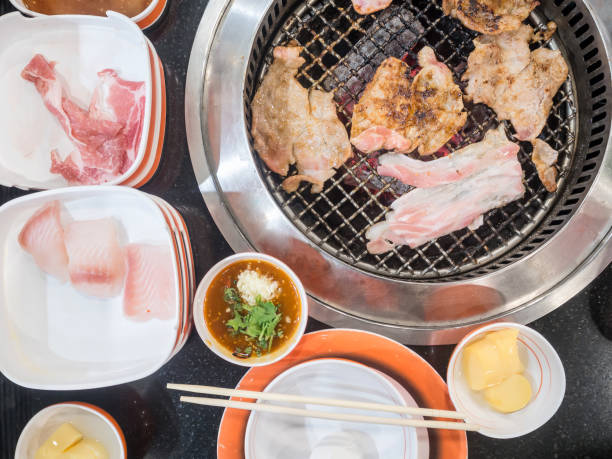 istock Streaky pork grilling on charcoal stove, Top view. 852236762