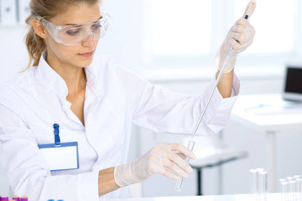 female scientific researcher in laboratory studying substances. medicine and science concept - close up medical test exam people imagens e fotografias de stock