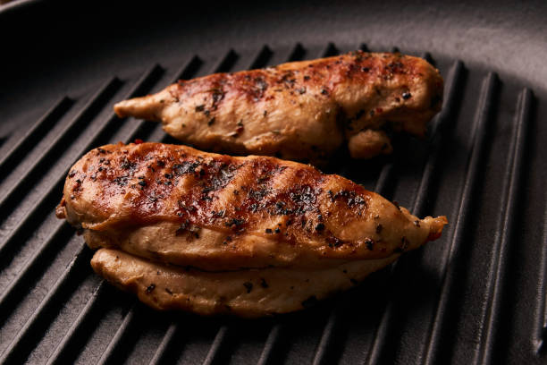 istock Grilled chicken breast fillets on black ribbed cooking pan 852245040
