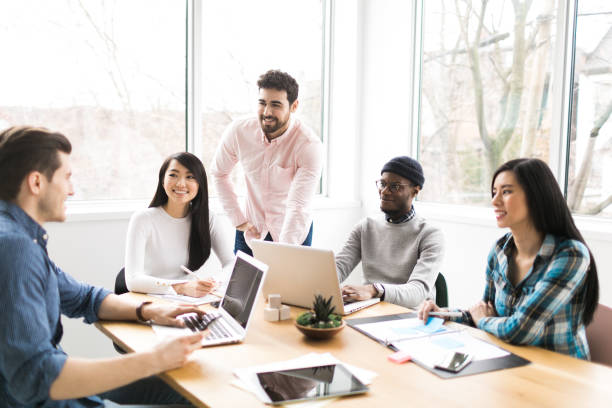 istock Young professionals working on laptops in an office 852252496