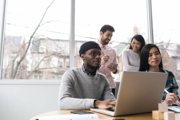 istock Young professionals working on laptops in an office 852252506
