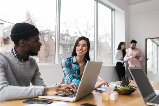 istock Young professionals working on laptops in an office 852252546