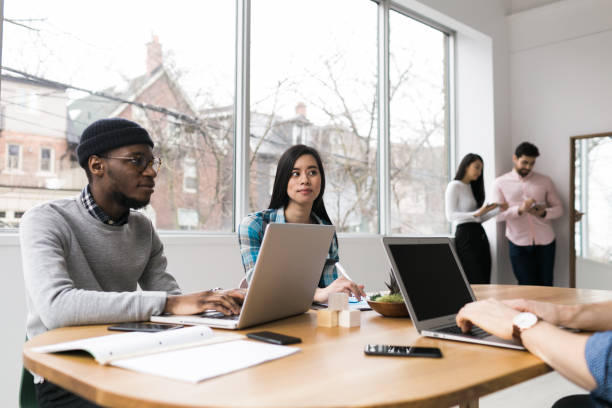 istock Young professionals working on laptops in an office 852252550