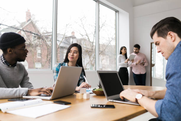 istock Young professionals working on laptops in an office 852252554