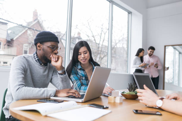 Young professionals working on laptops in an office