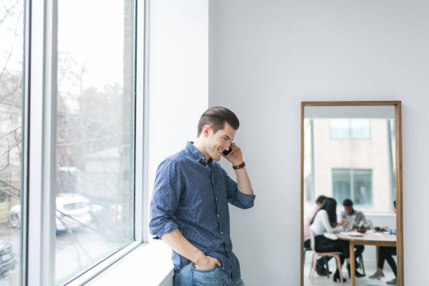 istock Young man talking on a cell phone in an office 852252596
