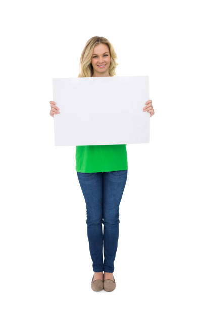cheerful cute blonde holding white sign - placard women holding standing imagens e fotografias de stock