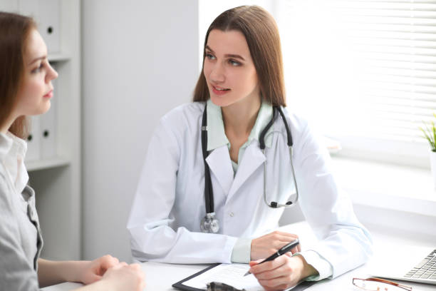 istock Female doctor having a talk with her patient  while sitting at the table near the window in hospital. Physician is ready to help patient. Medicine and health care concept 852257120