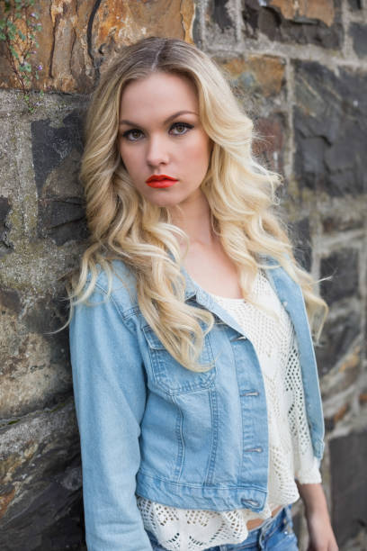 istock Pretty blonde wearing denim clothes posing outdoors 852270636