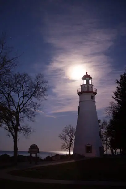 Night Shot of the marblehead lighthouse with the supermoon in the background