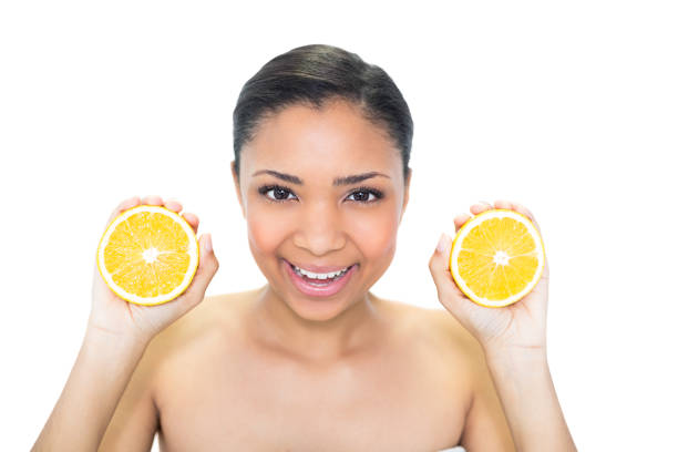 istock Joyful young dark haired model holding orange halves 852276154