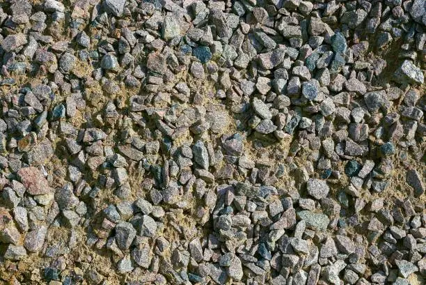 Photo of Texture of small stones and gray sand