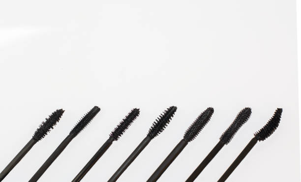 istock Different brushes of mascara on white background. Brushes for mascara below, top place for inscription and advertising 852281644