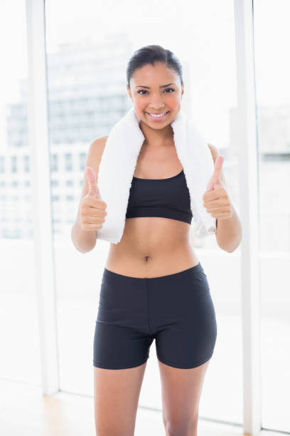 istock Confident dark haired model in sportswear giving thumbs up 852282114