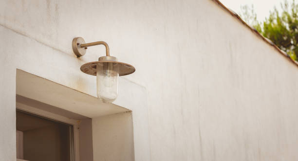 istock Modern metal hanging lamp in front of a window on a wall 852289036