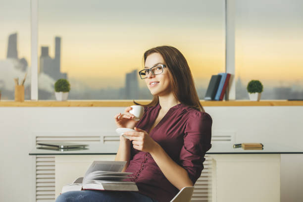 istock Woman reading book and drinking coffee 852293524
