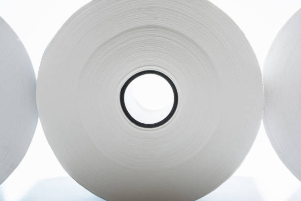 three rolls of white paper with black coils on white background, abstract background