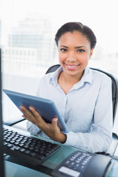 istock Smiling young dark haired businesswoman using a tablet pc 852301420