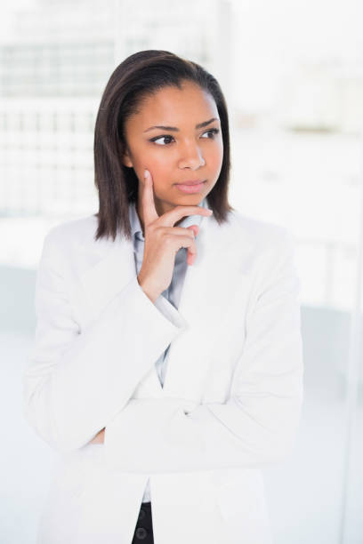 istock Thoughtful young dark haired businesswoman posing looking away 852310832