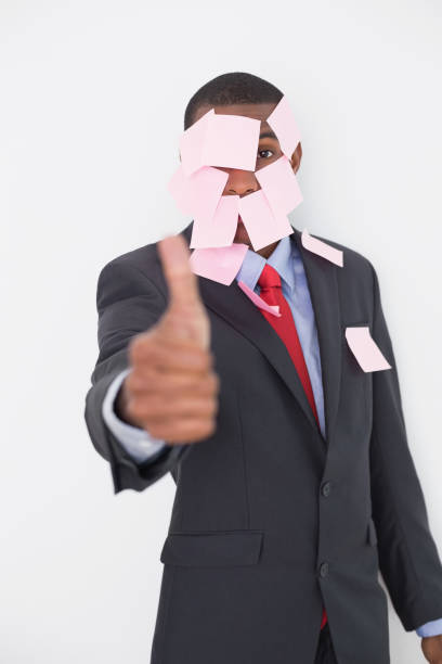 istock Afro businessman covered in blank notes gesturing thumbs up 852318514