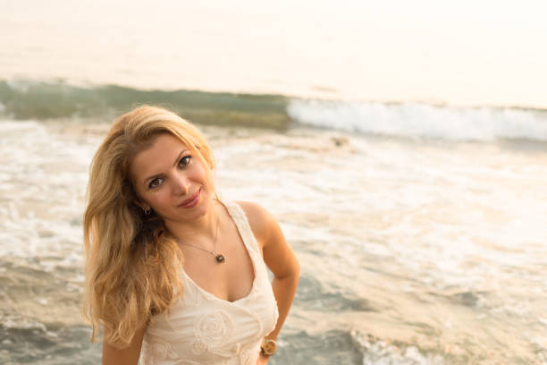 istock Beautiful blonde woman by seaside 852325964